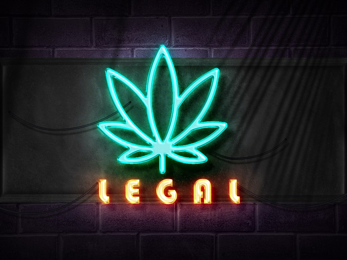 neon marijuana symbol with the word "legal" below