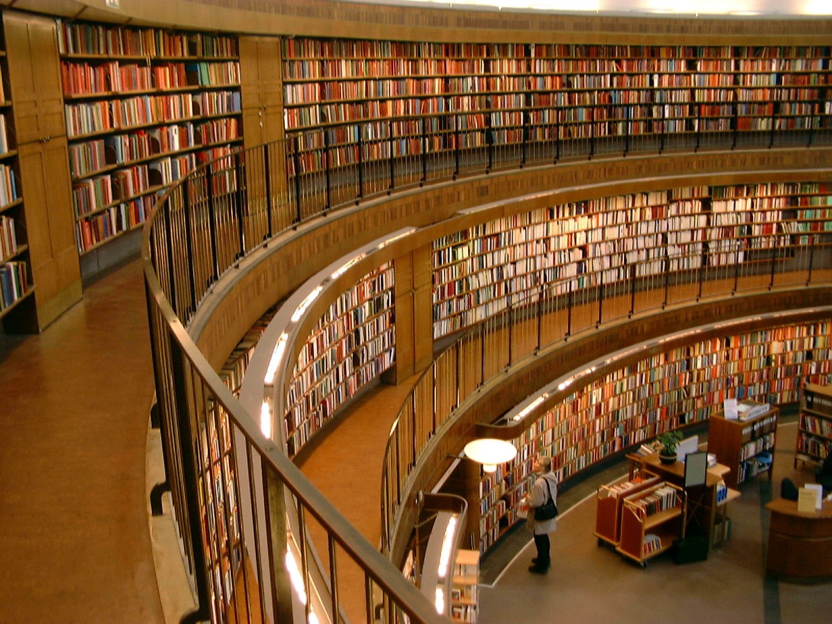 Rows of books line the walls of the public library in Stockholm, Sweden