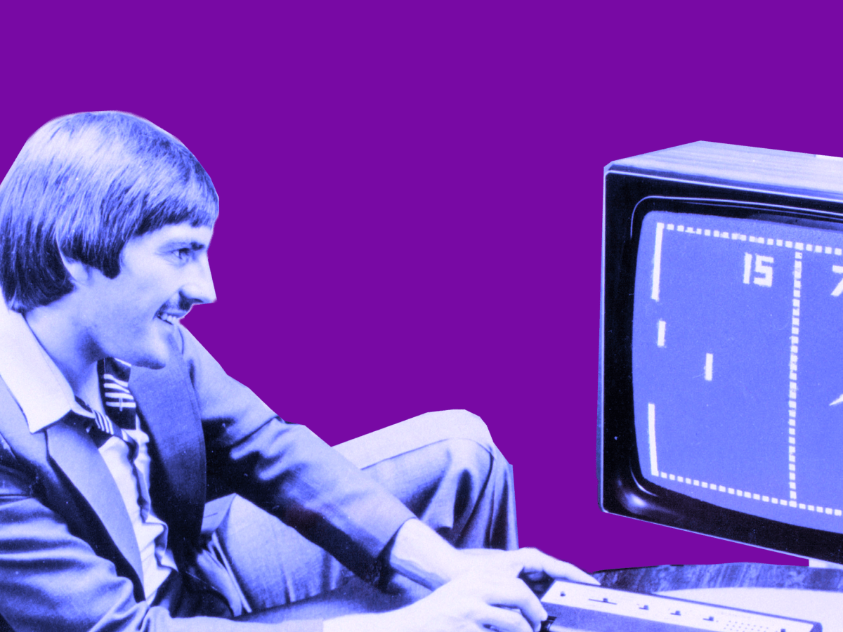 A man with a ’70s bowl haircut and a mustache sits in a low-slung chair, playing Pong on a small television. Photo is tinted blue and set against a dark purple background.