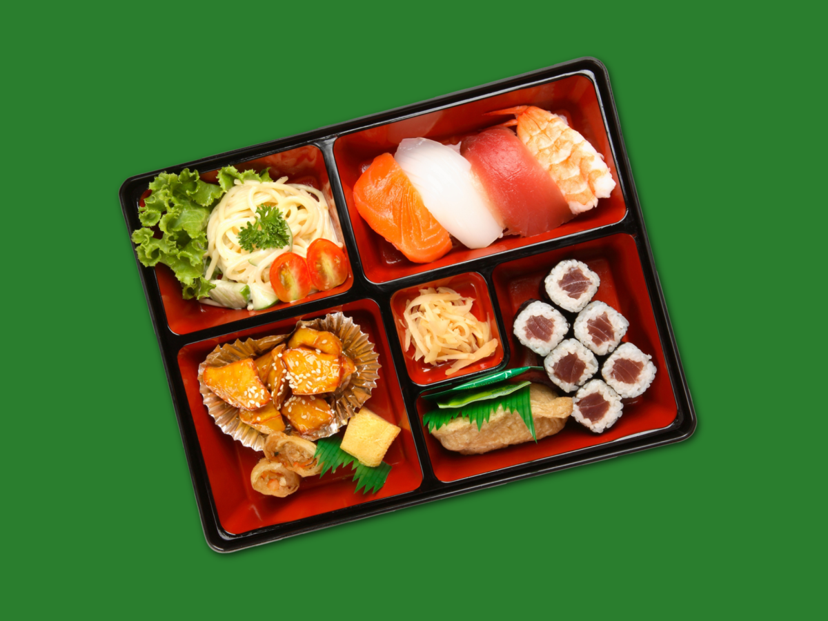 A yummy looking bento box on a bright green background