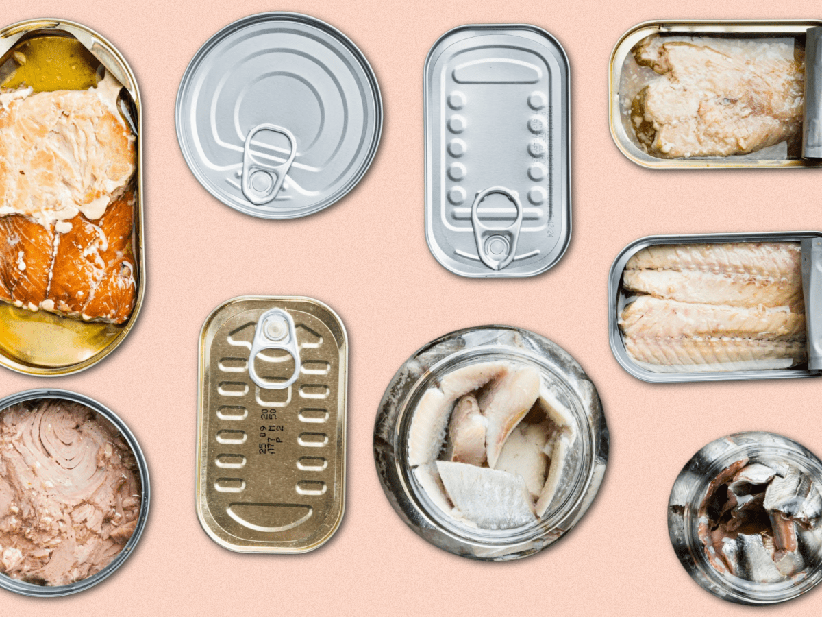 Various cans of tuna against a light pink background